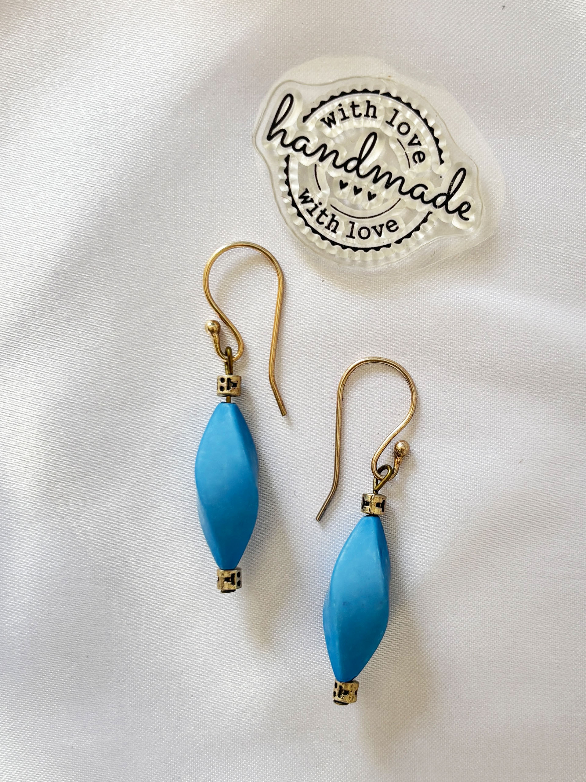 Aqua Breeze Earrings - These minimalist drop earrings feature smooth light blue beads paired with delicate gold accents—creating a calm and refreshing look.