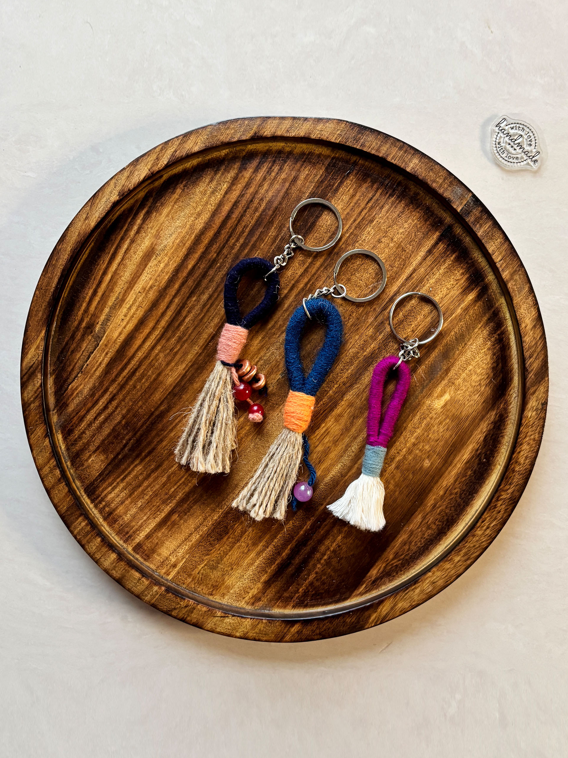 Boho Tassel Keychains - Fun, vibrant, and full of personality. These handmade tassel keychains feature colorful thread-wrapped loops paired with soft jute tassels and playful bead accents. Each piece is uniquely designed, making it a perfect little accessory to brighten your keys, bags, or gifts.