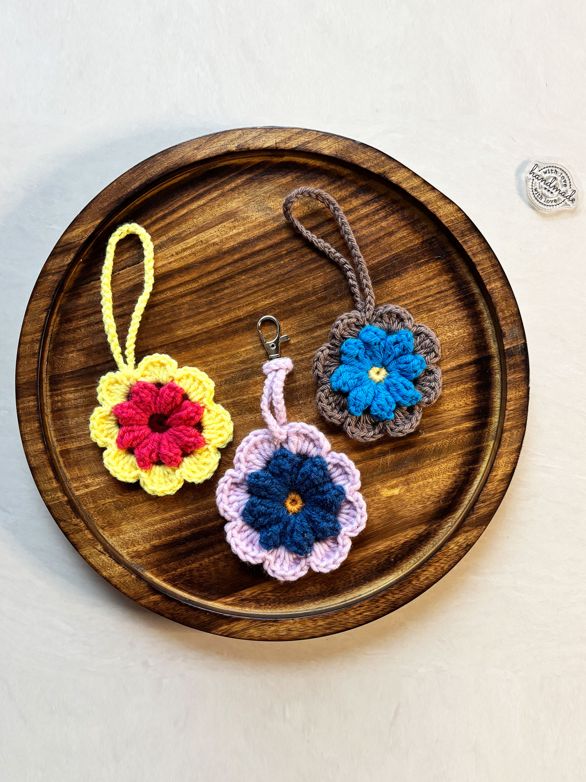 Daisy Luggage Tags - These handmade crochet luggage tags are a perfect blend of charm and practicality. Designed in beautiful floral patterns with vibrant yarn colors, they make your bags easy to spot while adding a playful, personal touch.