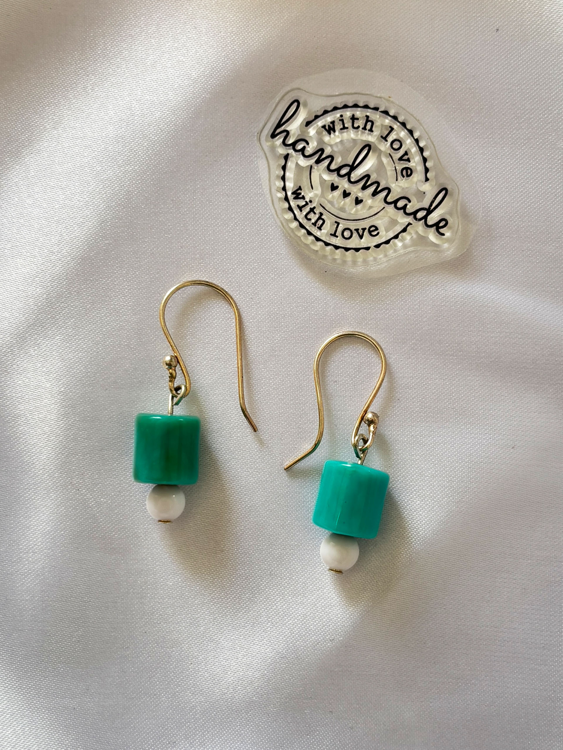 Mint Cube Earrings - These elegant earrings feature soft mint green cube beads paired with delicate white accents and gold-tone hooks. The clean geometric shape combined with soothing colours creates a modern, minimal look that’s perfect for everyday wear.