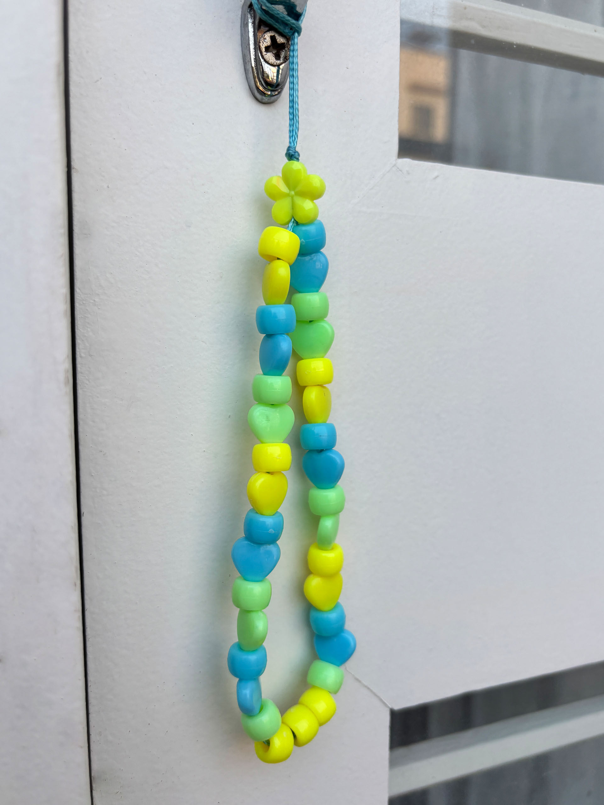 Sunny Pop Beaded Charm - Add a cheerful pop of color to your everyday essentials with this playful beaded charm strap.
