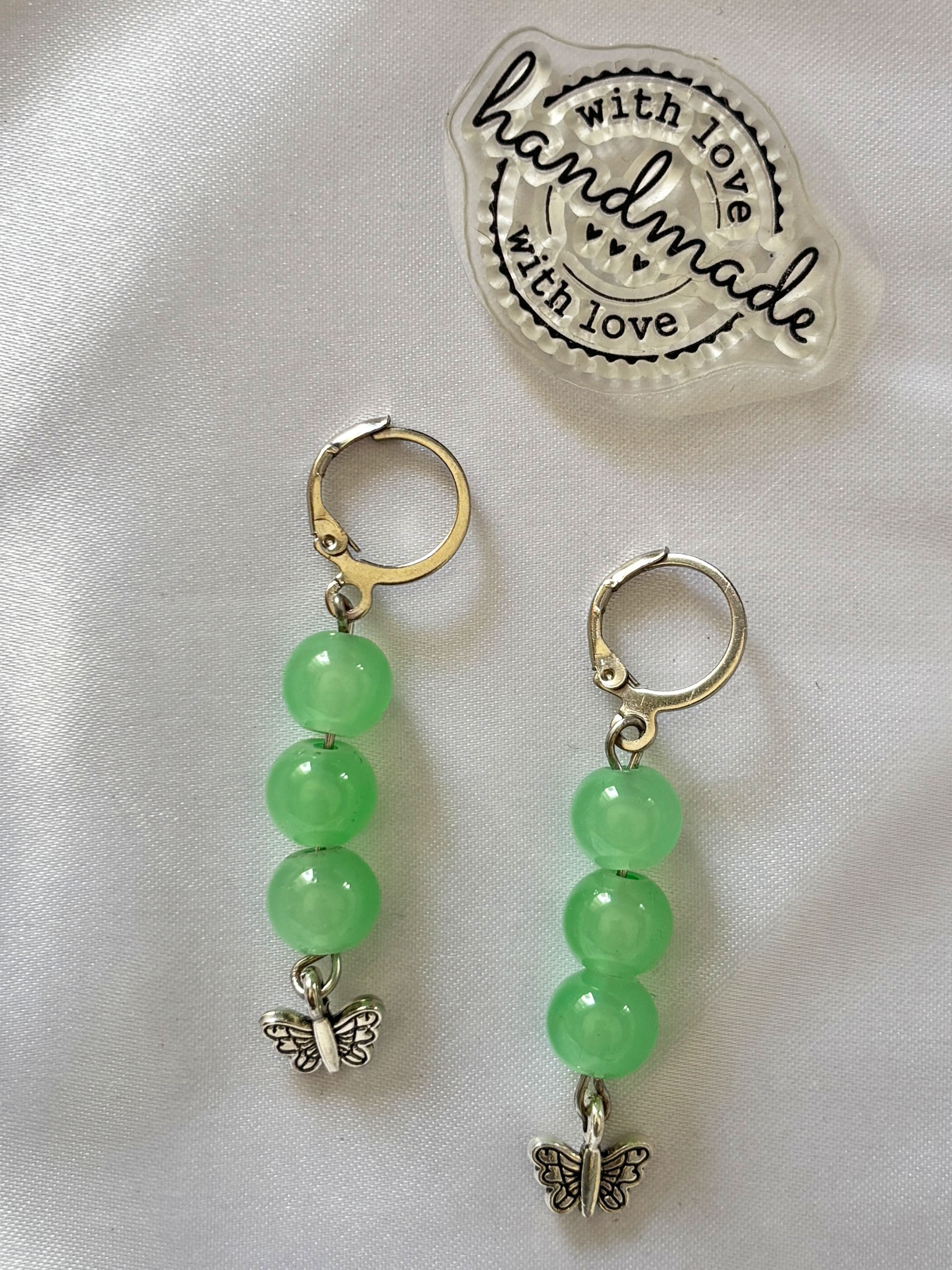 Fresh Mint Charm Drops - Fresh, soft, and effortlessly pretty, these mint green drop earrings bring a light and playful vibe to your style. Featuring smooth, glossy beads in a soothing pastel green, they create a clean and calming look that’s easy to pair with any outfit.